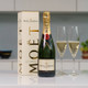 Moet Chandon Nv Gift Boxed Champagne: A bottle of Moët & Chandon champagne is displayed alongside two filled flutes. The champagne is housed in a decorative box featuring the brand’s name. The background is neutral, with hints of a plant and dishware visible. Moet Chandon Nv Gift Boxed Champagne: A bottle of Moët & Chandon champagne is displayed alongside two filled flutes. The champagne is housed in a decorative box featuring the brand’s name. The background is neutral, with hints of a plant and dishware visible.